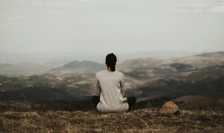 A person being mindful at a retreat
