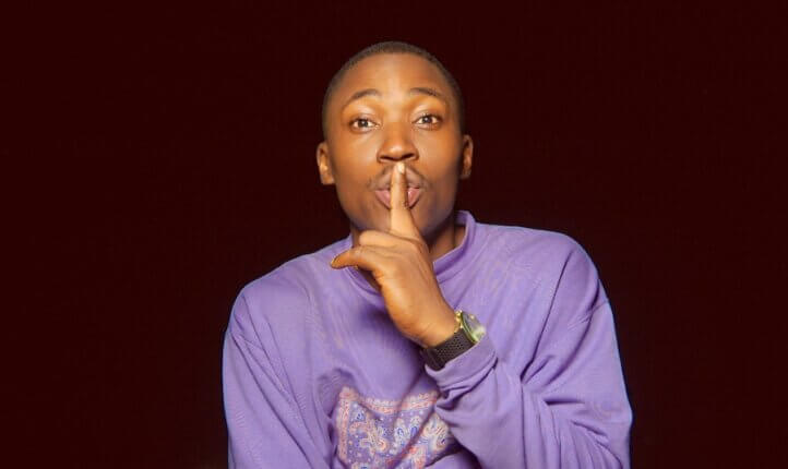 Image of a man making a a 'shush' gesture (symbolising taming your inner critic as a coach)