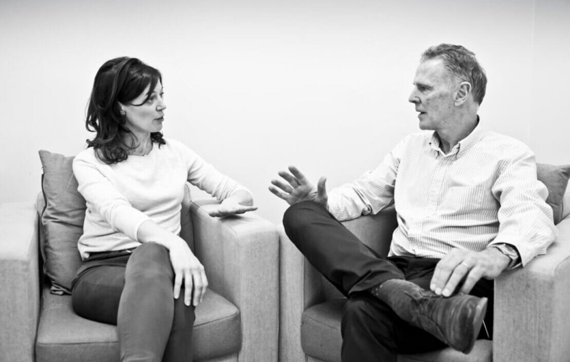 Image of two people having a coaching conversation — such conversations can be enhanced via an awareness of reactive tendencies