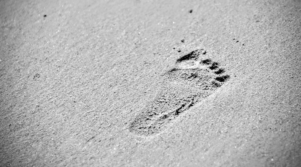 Image of a footprint in the sand, symobolising impermanence