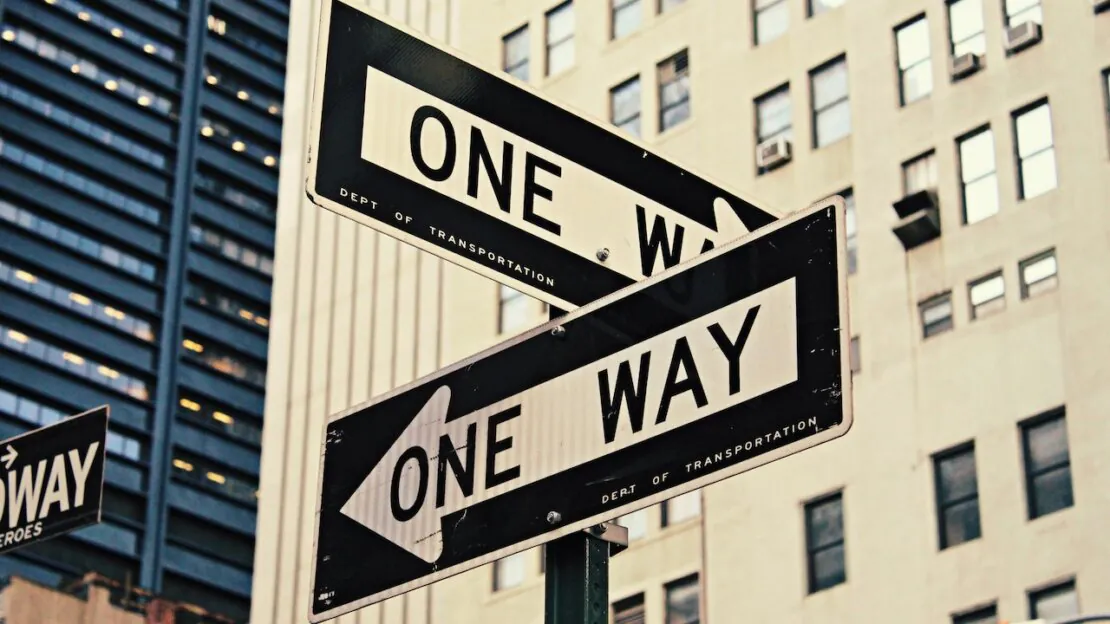 Image of two signs pointing in separate directions.