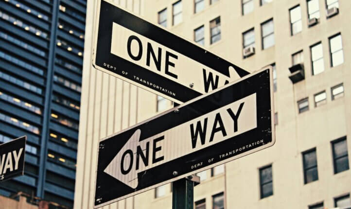 Image of two signs pointing in separate directions.